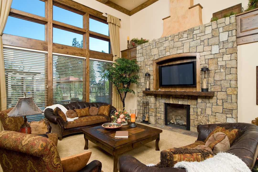 Rustic style room with a TV mounted above a fireplace.