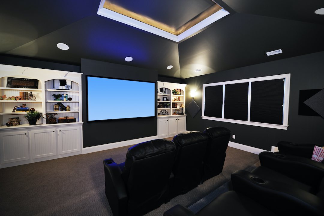 Home theater setup with a projector screen.
